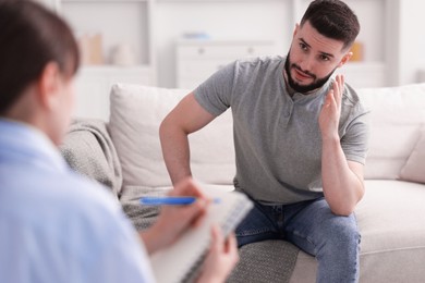 Photo of Professional psychologist working with patient in office, closeup