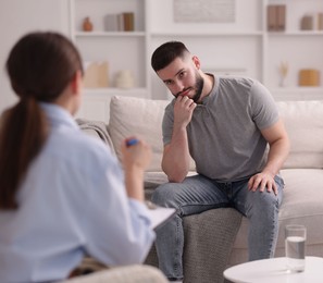 Photo of Professional psychologist working with patient in office, selective focus