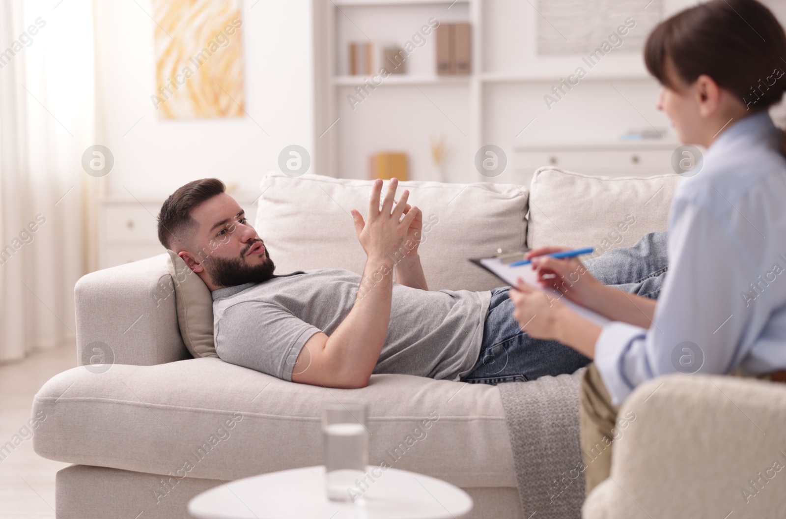 Photo of Professional psychologist working with patient in office, selective focus