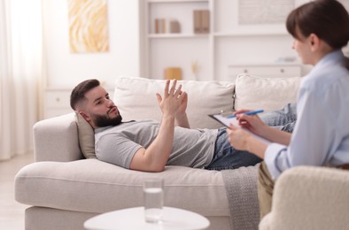 Photo of Professional psychologist working with patient in office, selective focus