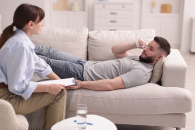 Photo of Professional psychologist working with patient in office
