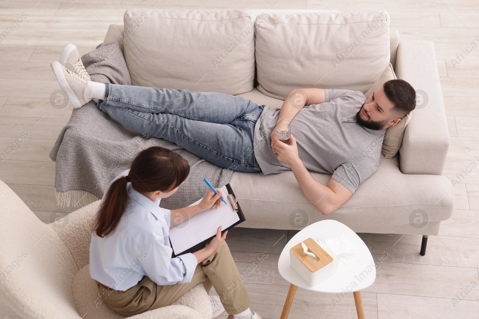 Photo of Professional psychologist working with patient in office, above view