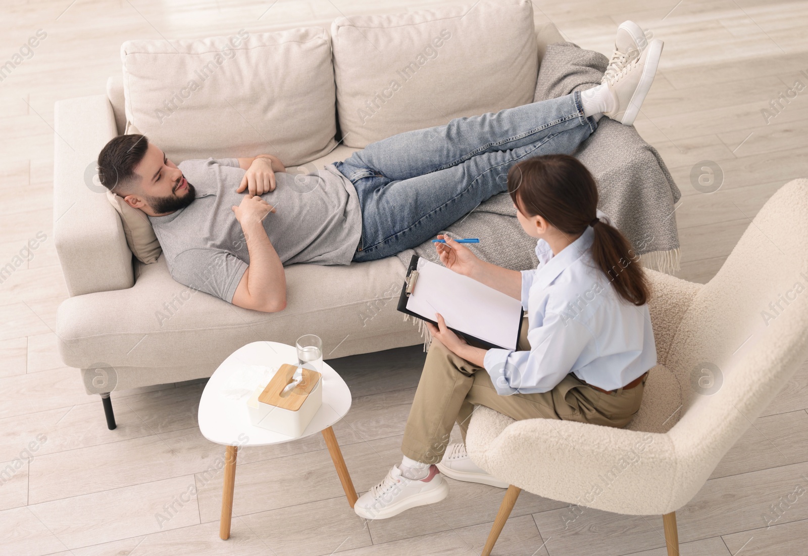 Photo of Professional psychologist working with patient in office, above view