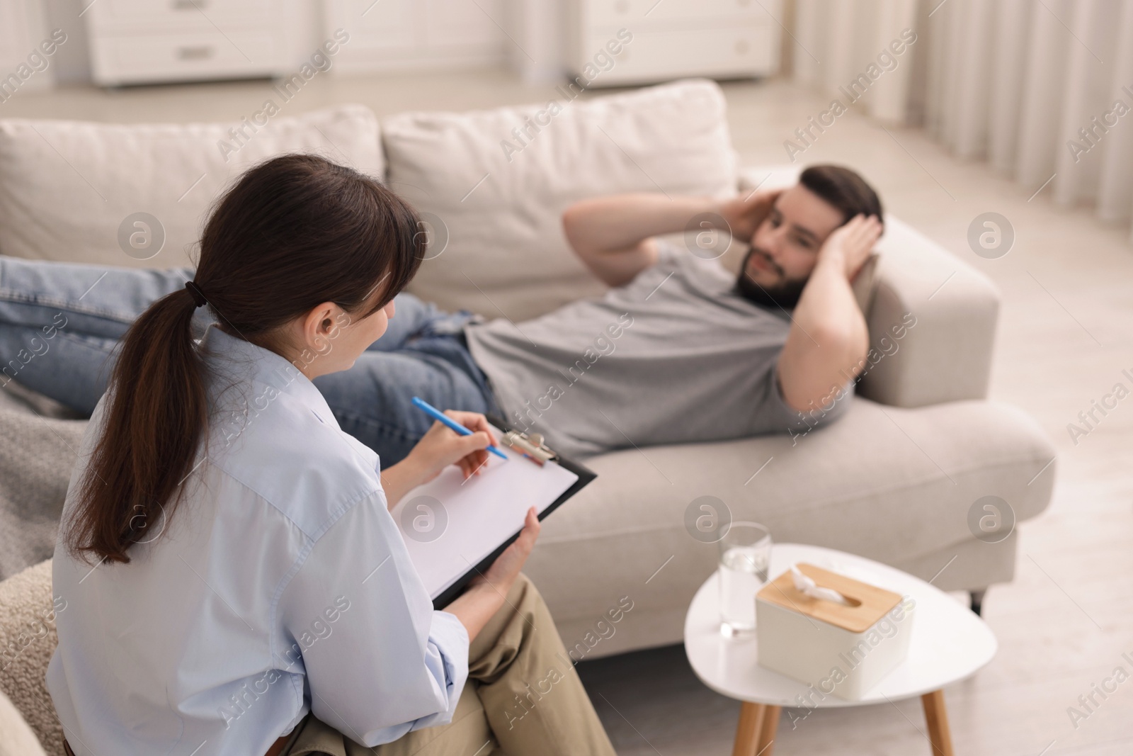 Photo of Professional psychologist working with patient in office, selective focus