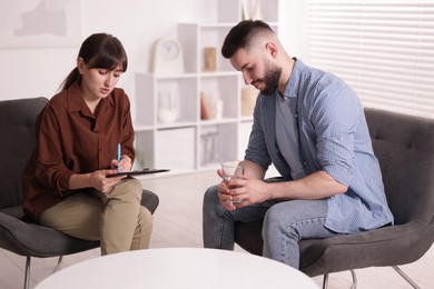 Photo of Professional psychologist working with patient in office