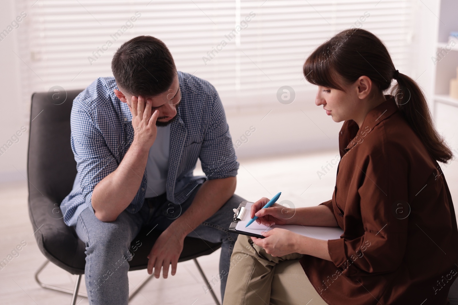 Photo of Professional psychologist working with patient in office