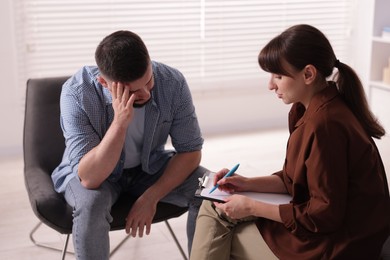Photo of Professional psychologist working with patient in office