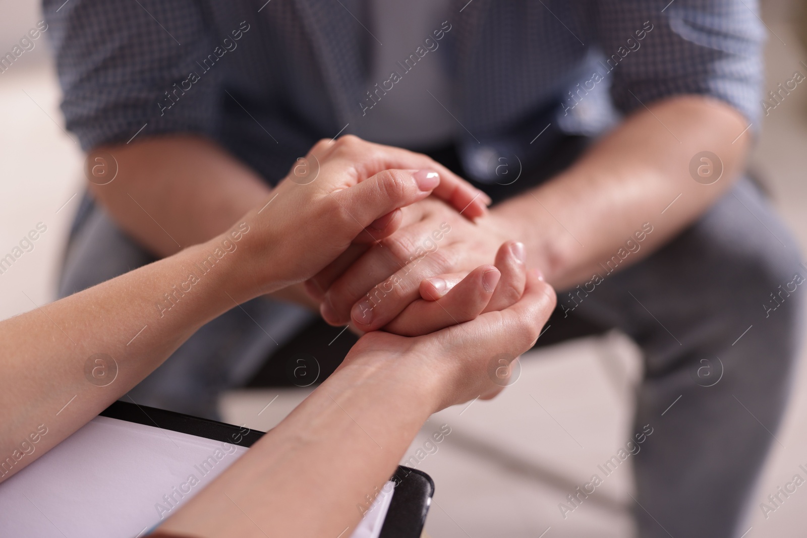 Photo of Psychologist supporting patient during therapy session in office, closeup