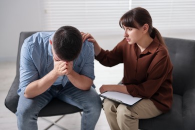 Photo of Psychologist supporting patient during therapy session in office