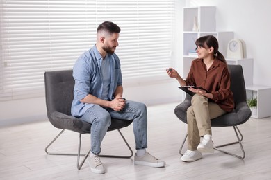 Photo of Professional psychologist working with patient in office