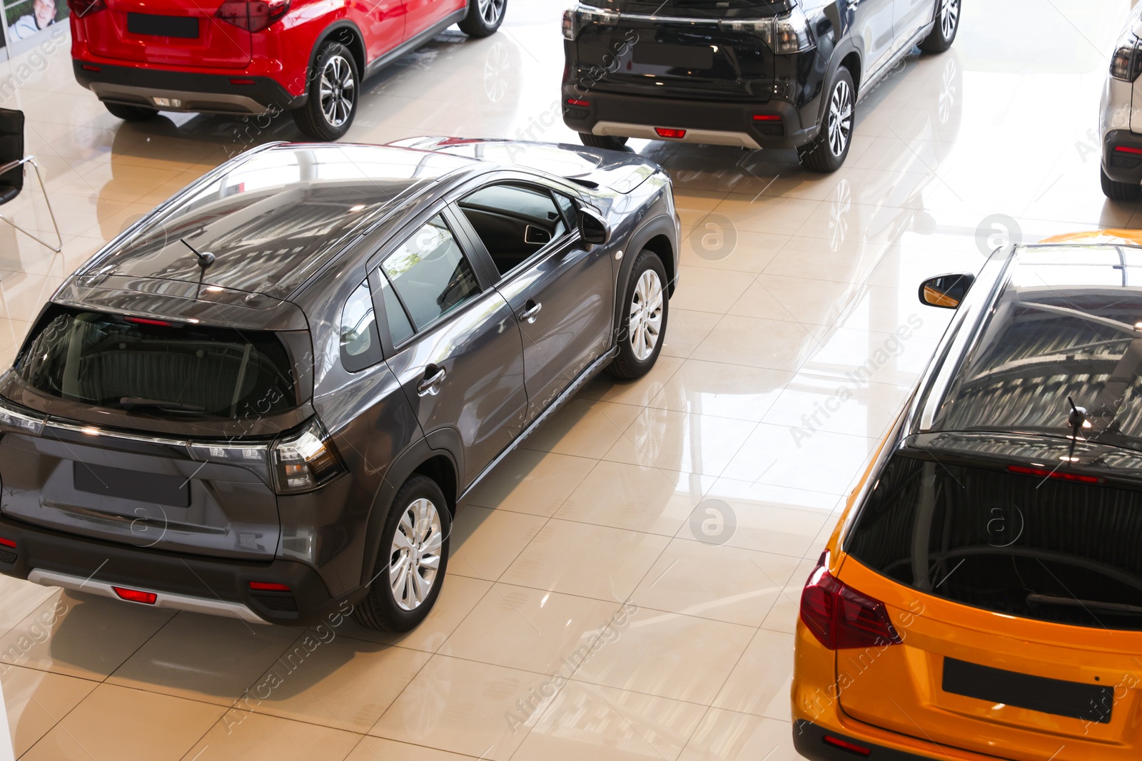 Photo of Many luxury new cars in salon. Modern transport