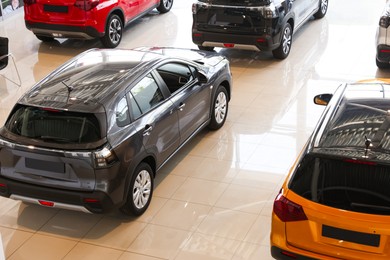 Photo of Many luxury new cars in salon. Modern transport