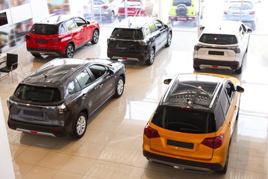 Photo of Many luxury new cars in salon. Modern transport
