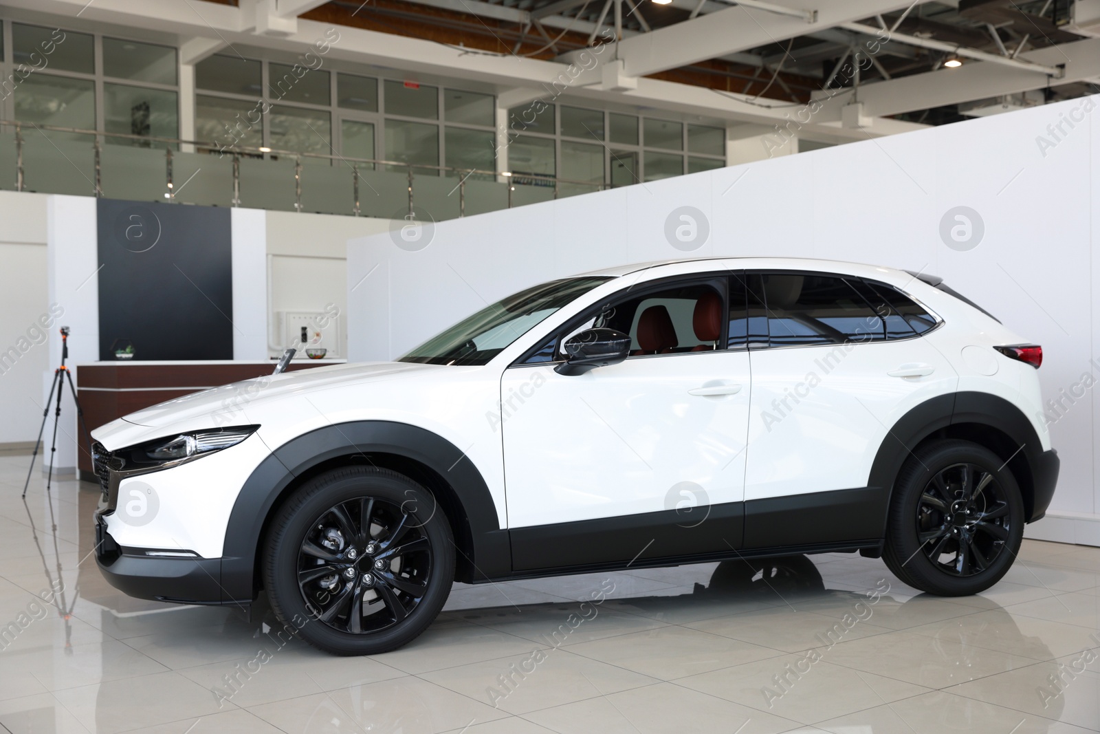 Modern white car in salon. Luxury vehicle Photo of Modern white car in salon. Luxury vehicle