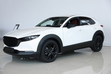 Photo of Modern white car in salon. Luxury vehicle