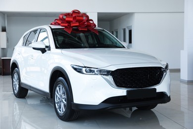 Photo of Modern white car in salon. Luxury vehicle