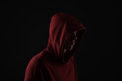 Photo of Anonymity. Man hiding his face in darkness
