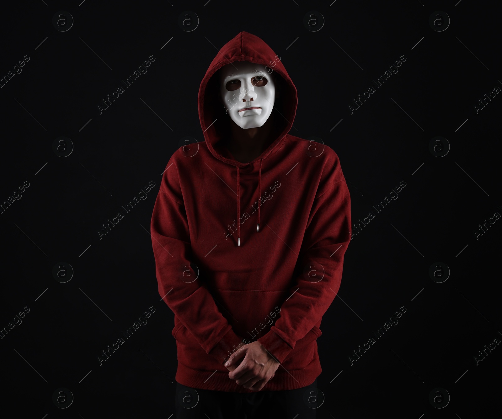 Photo of Anonymity. Man wearing mask on dark background