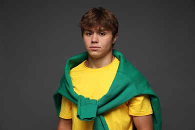 Photo of Portrait of cute teenage boy on grey background