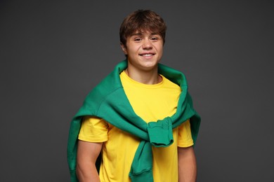 Photo of Portrait of smiling teenage boy on grey background