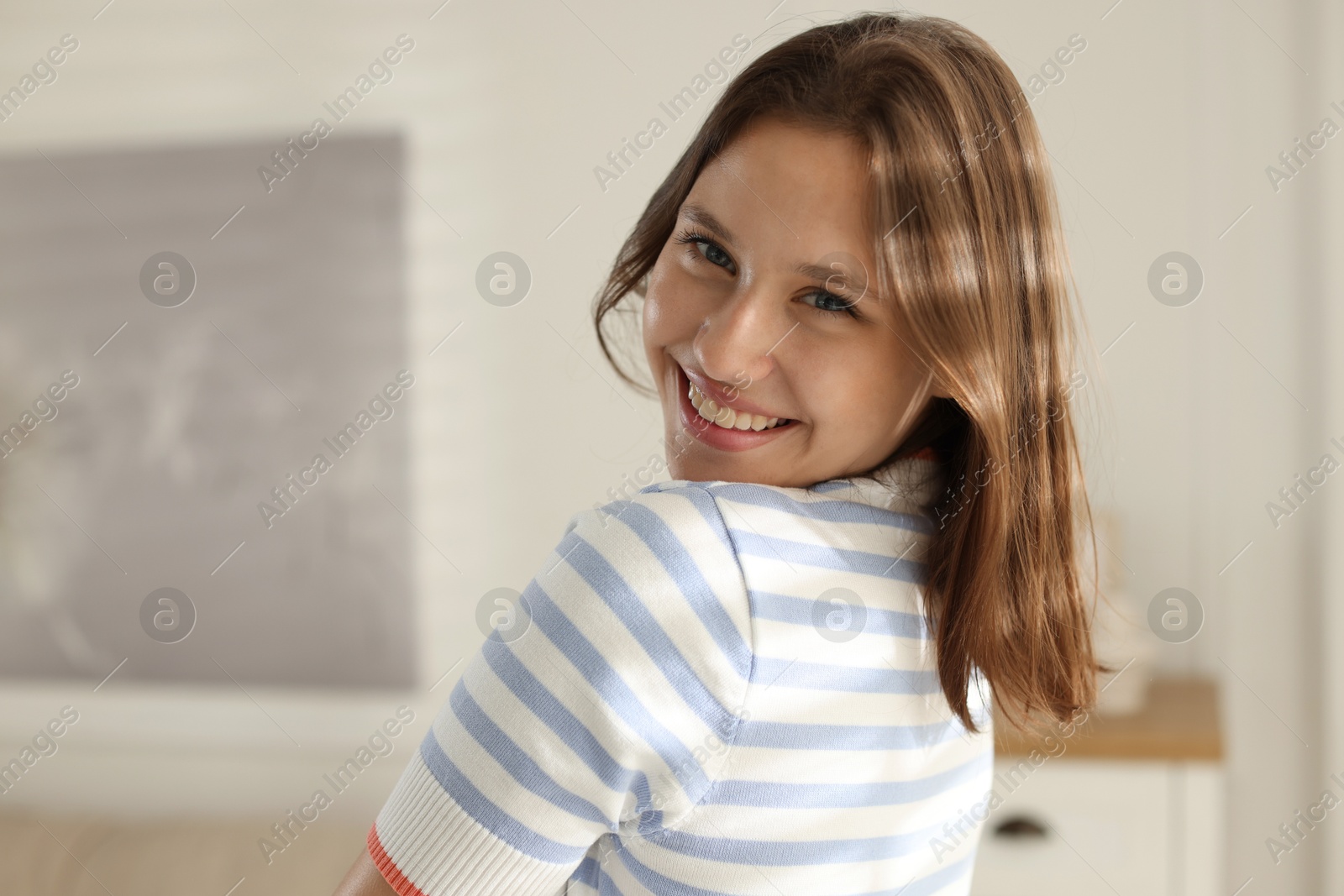 Portrait of smiling teenage girl at home Photo of Portrait of smiling teenage girl at home