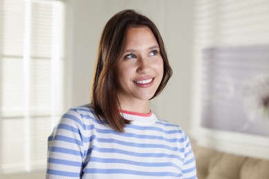 Photo of Portrait of smiling teenage girl at home