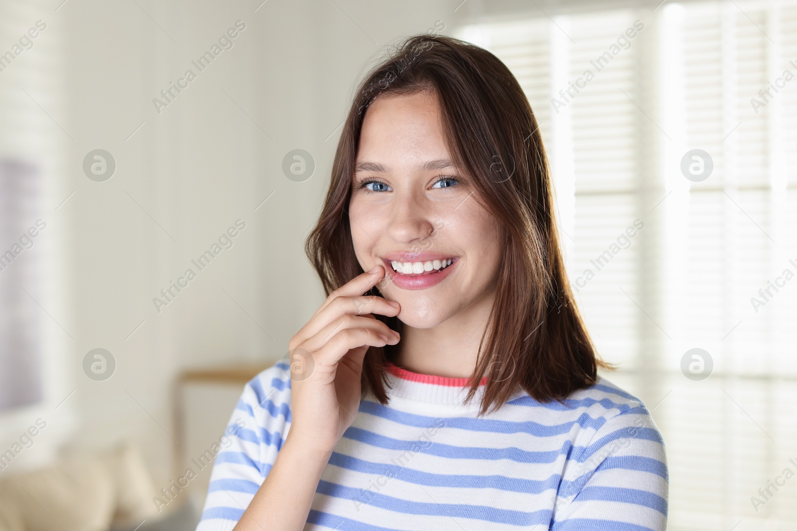 Portrait of smiling teenage girl at home Photo of Portrait of smiling teenage girl at home