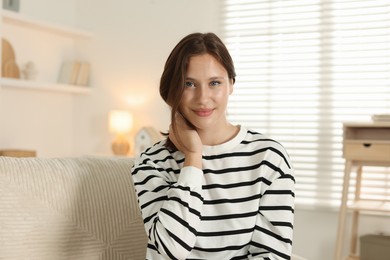 Photo of Portrait of beautiful teenage girl on sofa at home