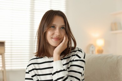 Photo of Beautiful teenage girl on sofa at home