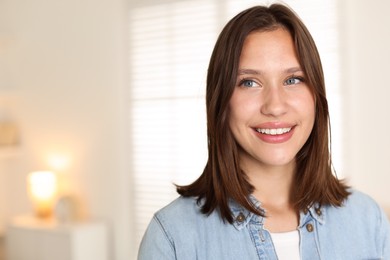 Photo of Smiling teenage girl at home. Space for text
