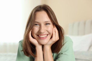 Photo of Portrait of smiling teenage girl at home