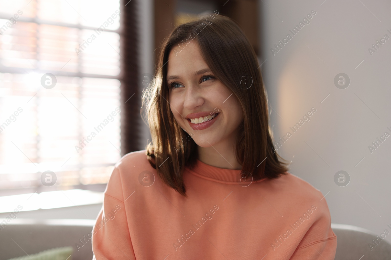 Portrait of smiling teenage girl at home Photo of Portrait of smiling teenage girl at home