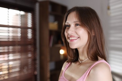 Photo of Smiling teenage girl at home. Space for text