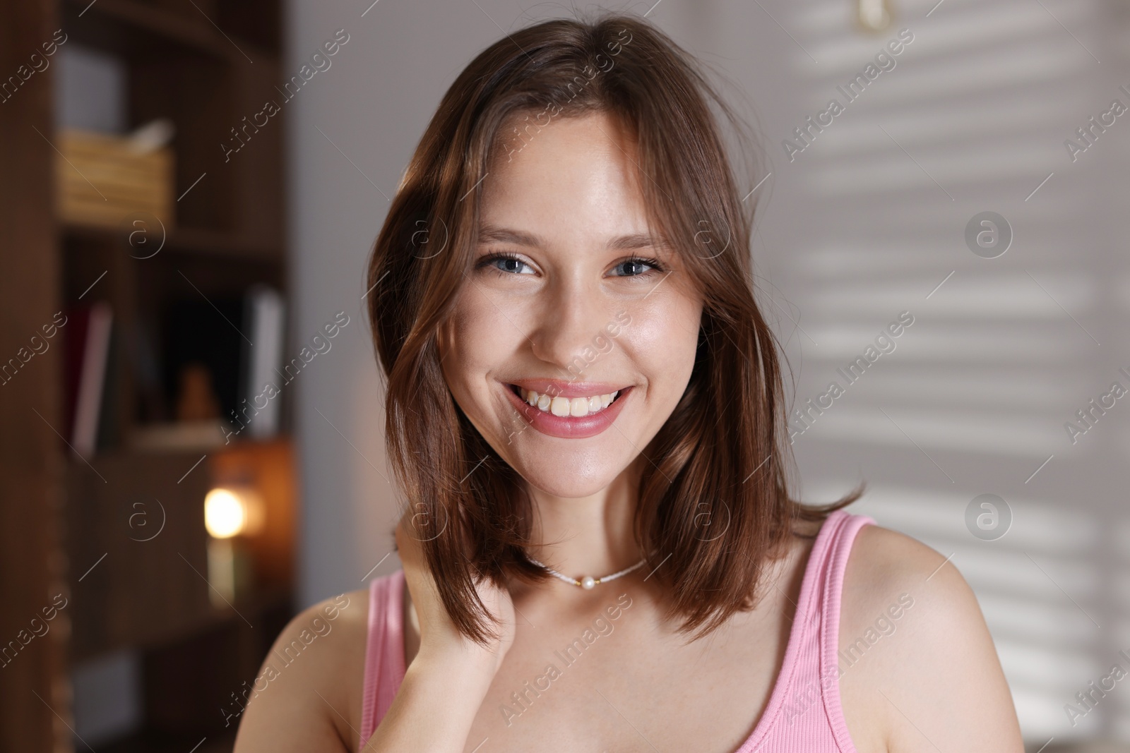 Portrait of smiling teenage girl at home Photo of Portrait of smiling teenage girl at home