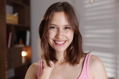 Photo of Portrait of smiling teenage girl at home