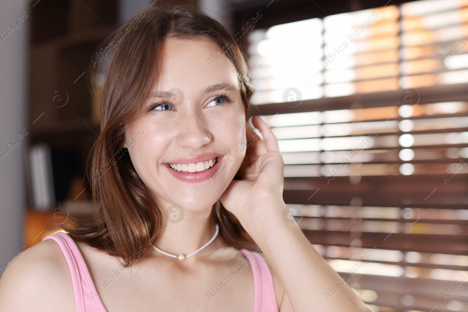 Portrait of smiling teenage girl at home Photo of Portrait of smiling teenage girl at home