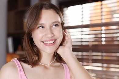 Photo of Portrait of smiling teenage girl at home