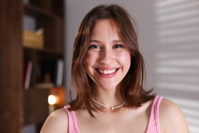 Photo of Portrait of smiling teenage girl at home