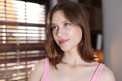 Photo of Portrait of beautiful teenage girl at home