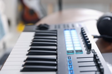Photo of One portable MIDI keyboard indoors, closeup view