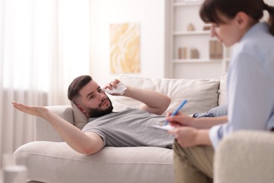 Photo of Professional psychologist working with patient in office, selective focus