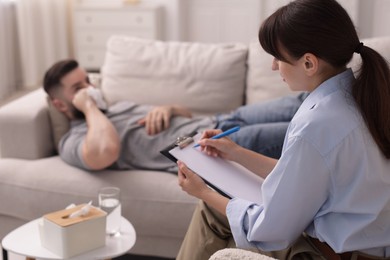 Photo of Professional psychologist working with patient in office, selective focus