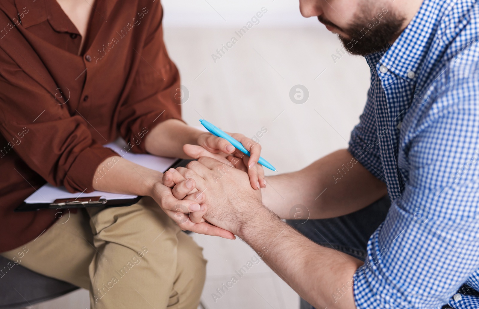 Photo of Psychologist supporting patient during therapy session in office, closeup