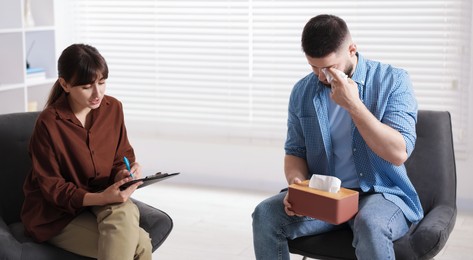 Photo of Professional psychologist working with patient in office