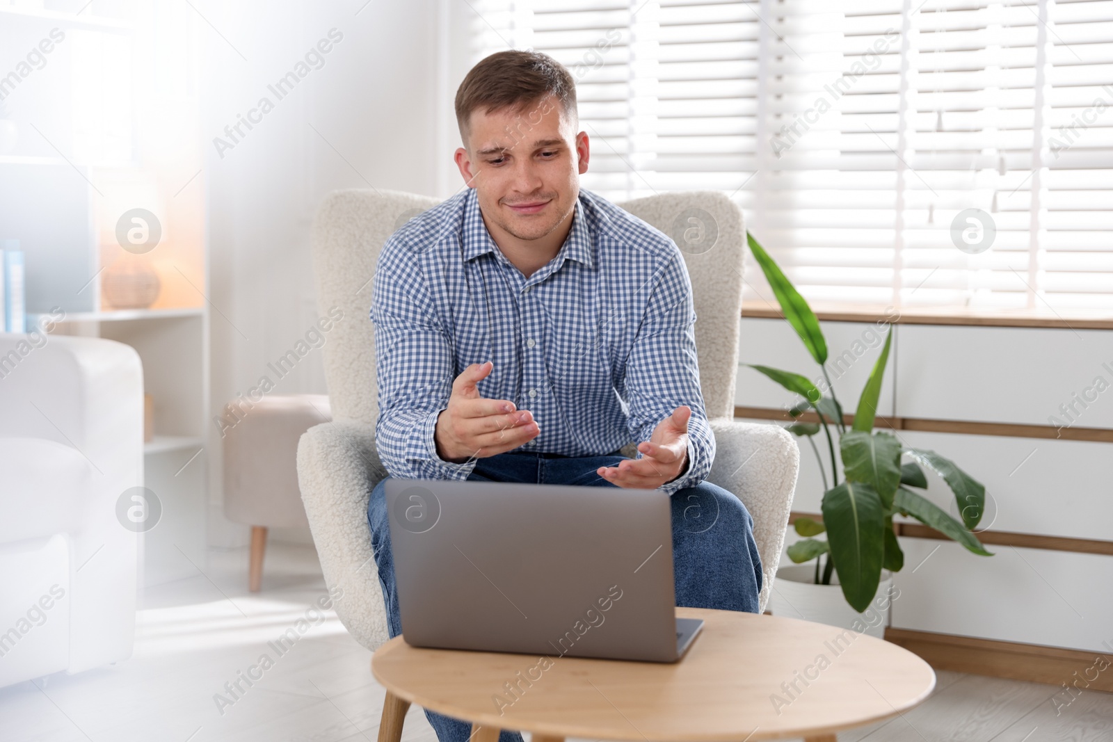 Photo of Psychologist during online session by laptop in office