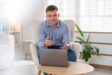 Photo of Psychologist during online session by laptop in office