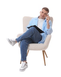 Photo of Thoughtful psychologist with clipboard sitting on armchair against white background