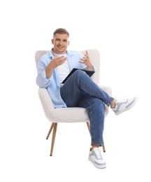 Photo of Smiling psychologist with clipboard sitting on armchair against white background
