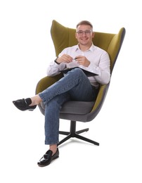Photo of Smiling psychologist in glasses with clipboard sitting on armchair against white background