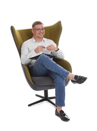 Photo of Smiling psychologist in glasses with clipboard sitting on armchair against white background